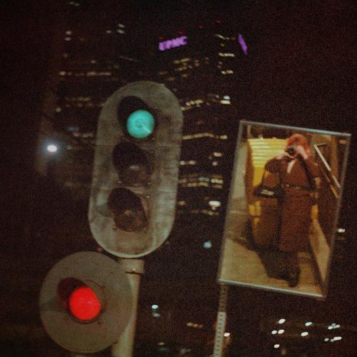 photograph of the upmc building in pittsburgh, with a mirror showing the photographer taking the photo